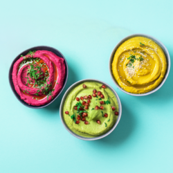 L'image représente différents hummus colorés à base de légumes sur un fond bleu. Les adeptes du régime Vegan sont-ils en carence de protéines ?