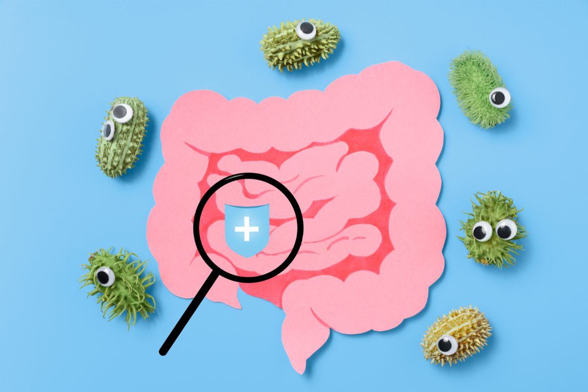 Une illustration conceptuelle montrant une loupe focalisée sur un intestin rose stylisé avec des microbes ayant des yeux, symbolisant une analyse détaillée de la flore intestinale dans le cadre du régime pauvre en FODMAP.