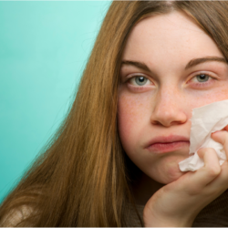 L'image représente une personne souffrant d'allergies, avec le nez rouge et un mouchoir à la main. La photothérapie intranasale Humer Votre solution à domicile contre les allergies